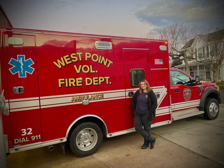 Elle stands in front of the West Point Volunteer Fire Department ambulance