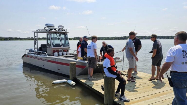 Kids and adults taking a boat ride on the West Point Volunteer Fire Department Boat