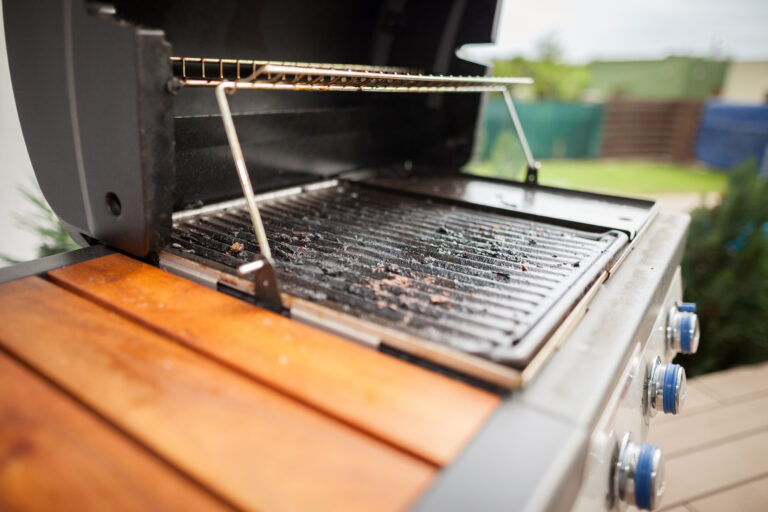 Very dirty grill after summer grilling (focus on grate)