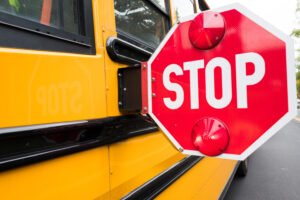 close up of a school bus stop sign on the side of a bus